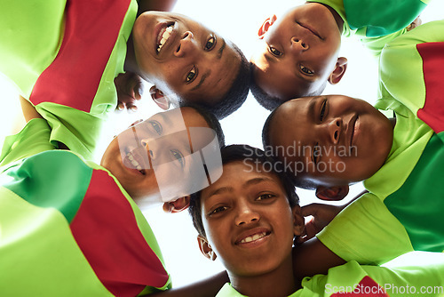 Image of When we play as a team, we rise as champions. Portrait of a boys soccer team standing together in a huddle.