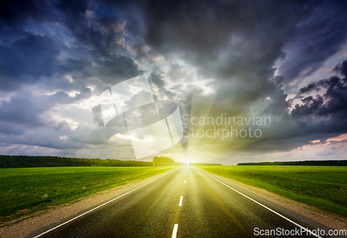 Image of Road and stormy sky on sunset