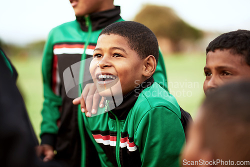 Image of When it comes to soccer, his eyes always sparkle with excitement. a young boy standing alongside his soccer team on a sports field.