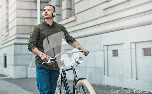 Image of Success comes to those who seek it. a young businessman riding a bicycle in the city.