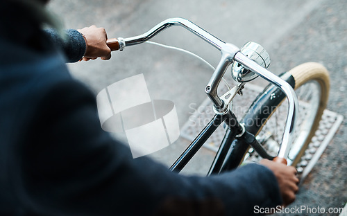 Image of Get a grip on your goals. an unrecognisable businessman riding a bicycle through the city.