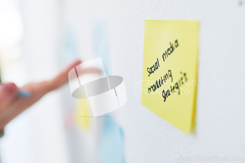 Image of Taking note of the big plan. Closeup shot of an unrecognisable businesswoman brainstorming with notes on a wall in an office.