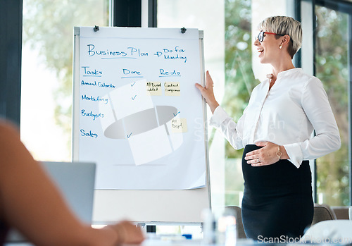 Image of These are our upcoming deadlines. a pregnant businesswoman using a whiteboard while giving a presentation in an office.