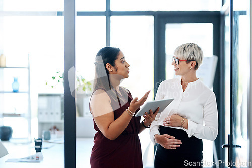 Image of Our collaboration makes us stronger. two businesswomen using a digital tablet together in an office.