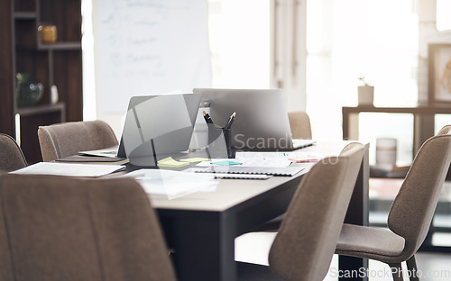 Image of Success is created in this space. Still life shot of laptops and paperwork on a table in a modern office.