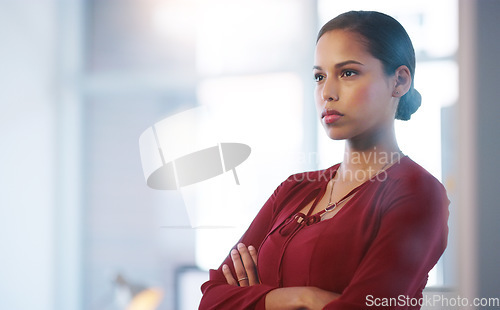 Image of Making sure everyone is doing their work. a confident young businesswoman standing with her arms folded inside of the office.