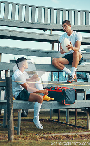 Image of Sharing some helpful tips. two rugby players having a conversation while sitting on a bench.