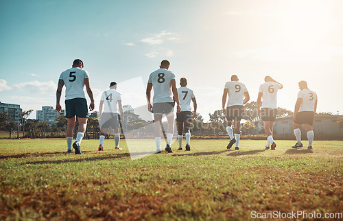 Image of Theyre champions whether they win or lose. Rearview shot of a group of young rugby players walking on a field.