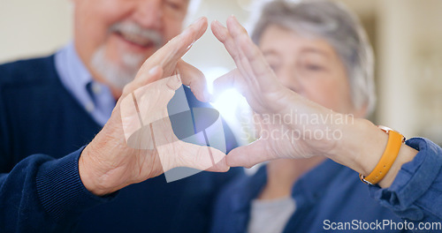 Image of Heart, hands and senior couple with love, trust and hope in their home bonding, relax and free. Gratitude, care and old people with thank you, finger or emoji frame for kindness, security or support