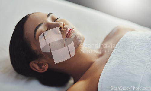 Image of Facials cleanse, exfoliate and nourishes the skin. a young woman getting a facial treatment at a spa.