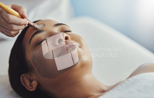 Image of Let the professionals help you get that glow. a young woman getting a facial treatment at a spa.