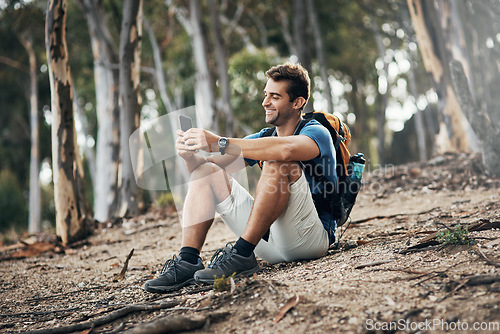 Image of Wish you could have joined me. a carefree young man taking a quick break from hiking up a mountain during the day.