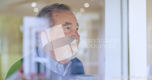 Image of Happy, thinking or face of an old man by window in retirement with ideas or memory in living room. Remember, smile or elderly male person by glass for nostalgia in home alone drinking tea or coffee