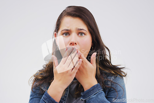 Image of I cant believe what Im seeing. Studio shot of a young woman looking shocked against a grey background.