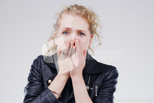 Image of No thats terrible. Studio shot of a young woman looking shocked against a grey background.