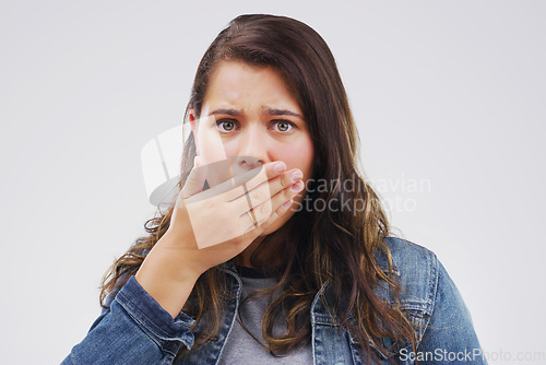 Image of Wait...are you sure. Studio shot of a young woman looking shocked against a grey background.