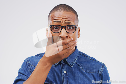 Image of No...you must be mistaken. Studio shot of a young man looking shocked against a grey background.