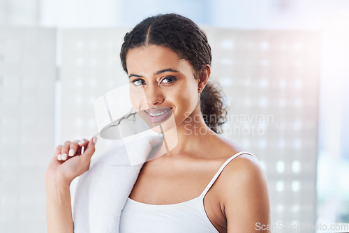 Image of Good morning to you too. an attractive young woman going through her morning beauty routine in the bathroom.