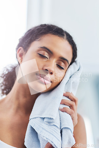 Image of My skin never felt this good. a young woman drying her face in the bathroom at home.