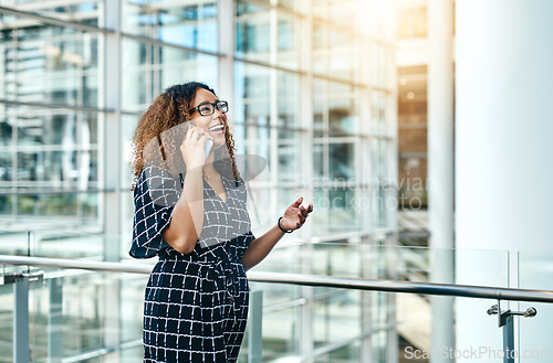 Image of Ive been waiting to hear from you all day. an attractive young businesswoman taking a phonecall while walking through a modern workplace.