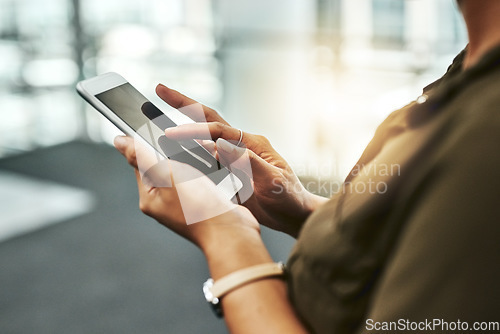 Image of You can make profitable connections with one tap. an unrecognizable businesswoman using a smartphone while standing in a modern office.