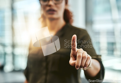 Image of Change is at the tip of your fingers. an unrecognizable businesswoman connecting to a user interface with her finger.