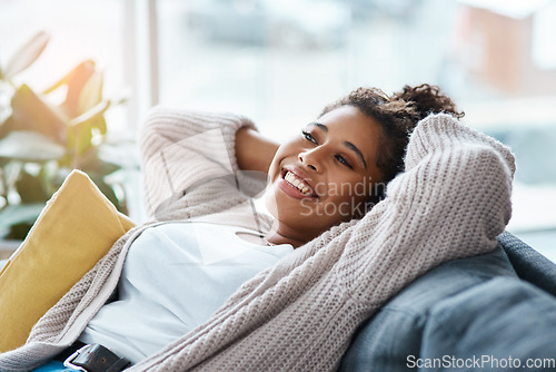 Image of Trust me home is the perfect place to relax. Cropped portrait of an attractive young woman relaxing on her couch at home.