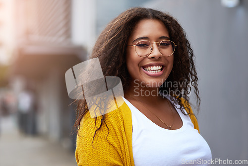 Image of Vibes positive only. Cropped portrait of a happy young woman standing outdoors in an urban setting.