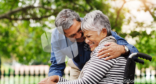 Image of Ill be right by your side every step of the journey. a happy wheelchair bound senior woman spending the day with her husband at the park.