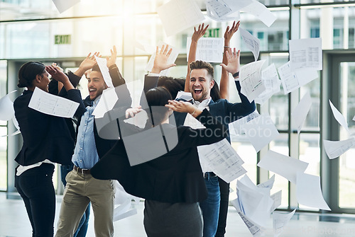 Image of They can be fun and silly. a group of cheerful businesspeople lifting their hands in joy while being funny inside of the office at work.