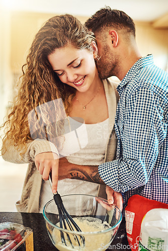 Image of We love making things in the kitchen. a loving couple baking in their kitchen.