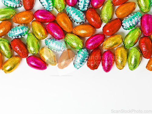 Image of This is what dreams are made of. Studio shot of a dazzling array of multicolored easter eggs wrapped in foil.