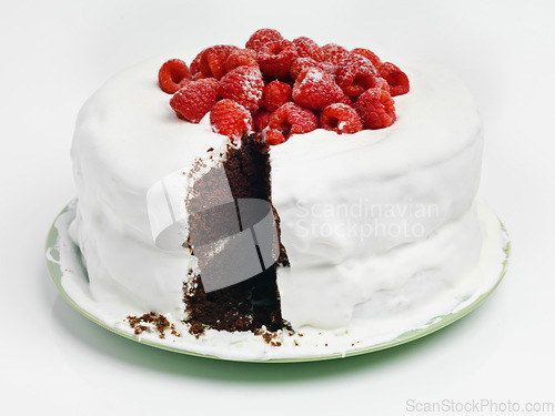 Image of When in doubt choose chocaolate. Studio shot of a delicious chocolate cake with frosting and raspberries.