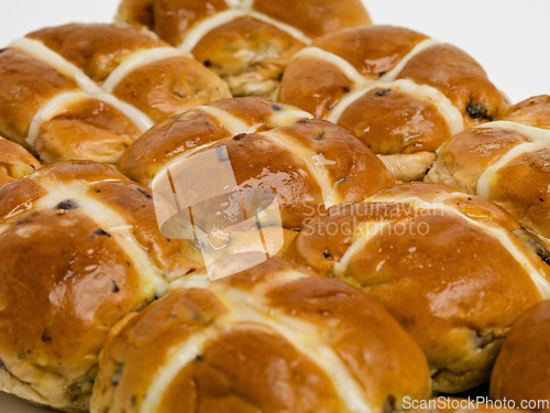 Image of Freshly baked goodness. Studio shot of freshly baked hot cross buns.