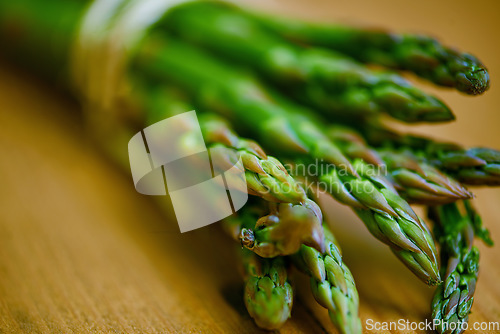 Image of Spears of goodness. Closeup of a bunch of green asparagus tied up with string.