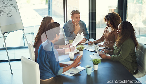 Image of Merging their efforts towards gaining success. a group of businesspeople having a meeting in an office.