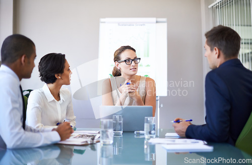 Image of Theyre an extremely ambitious team. A group of businesspeople listening to their colleague during a meeting.