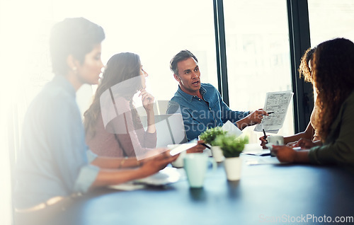 Image of We need to treat this task as a top priority. a group of businesspeople having a meeting in an office.