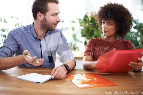 Image of In my opinion...two design professionals having a discussion while seated at a table.