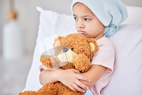 Image of Lets make you feel better. a little girl laying in bed at a hospital.