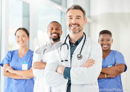 Image of He is king of the hospital. a group of medical practitioners standing together in a hospital.