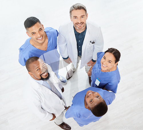 Image of Checking the stats as a team. a group of medical practitioners standing together in a hospital.