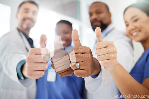 Image of Your health and safety is important to them. a group of doctors showing a thumbs up in a office.