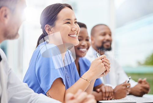 Image of Clinical care is becoming more complex and specialised. a doctor sitting alongside his colleagues during a meeting in a hospital boardroom.