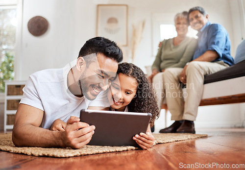 Image of Introducing her to the digital world. a young father and daughter using a digital tablet together at home.