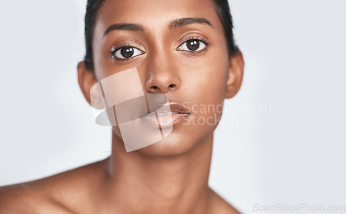 Image of Add a little more glow and less coverage. a beautiful young woman posing against a white background.