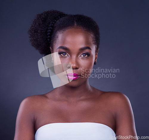 Image of Beauty is self-confidence applied directly to the face. Studio portrait of a beautiful young woman posing against a black background.