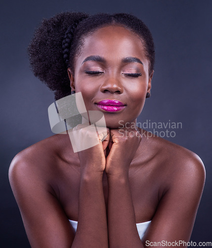 Image of Beauty is the illumination of your soul. Studio shot of a beautiful young woman posing against a black background.