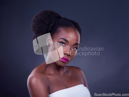 Image of Real beauty is to be true to oneself. Studio portrait of a beautiful young woman posing against a black background.