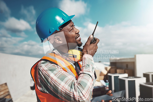 Image of Nothing keeps a project on task like consistent communication. a young man using a walkie talkie while working at a construction site.